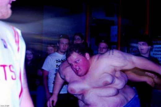 a man is dancing in the middle of a crowd